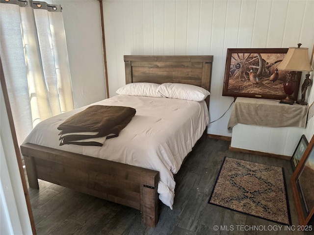 bedroom with dark hardwood / wood-style flooring