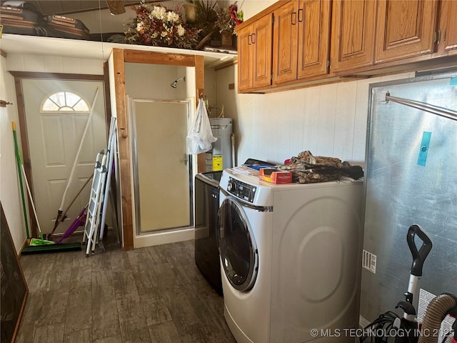 clothes washing area featuring independent washer and dryer, cabinets, water heater, and dark hardwood / wood-style flooring