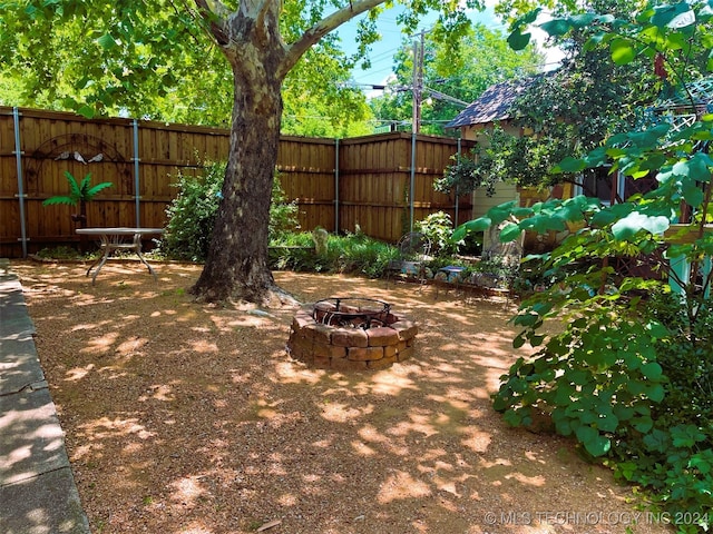 view of yard with an outdoor fire pit