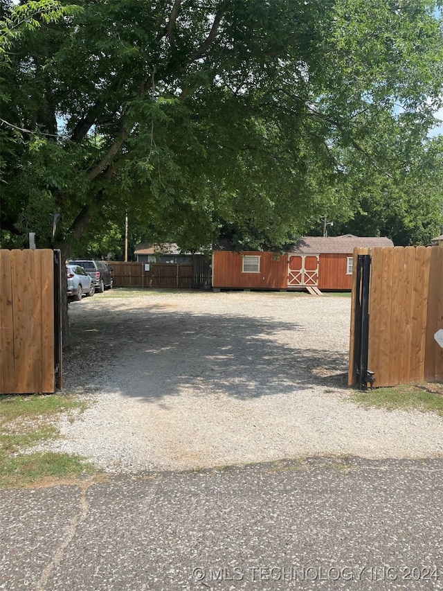 view of gate with an outbuilding