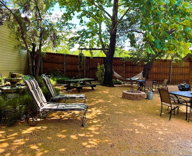 view of yard featuring a patio area and a fire pit