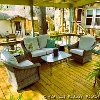 wooden deck featuring an outdoor living space