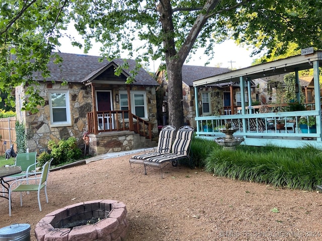 rear view of house featuring an outdoor fire pit