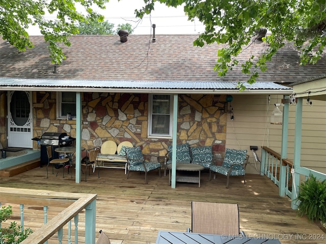 wooden deck with a grill