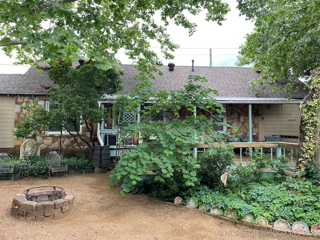 back of house featuring a fire pit