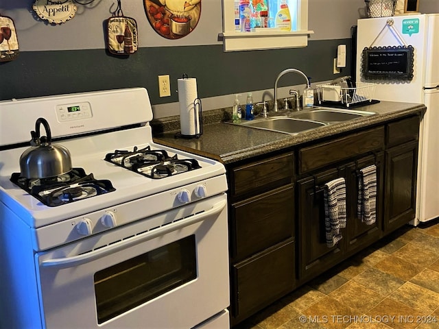 kitchen featuring dark brown cabinets, white appliances, and sink