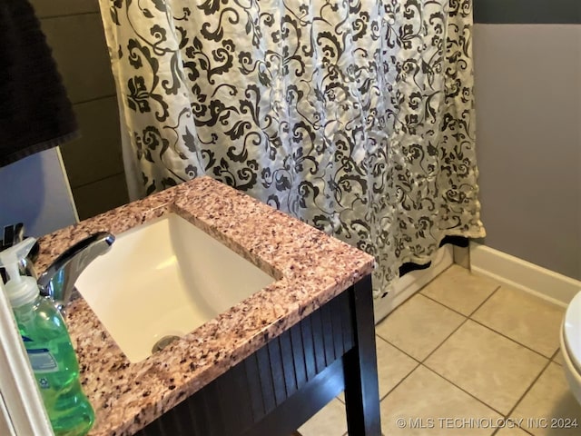 bathroom featuring vanity, toilet, a shower with shower curtain, and tile patterned floors