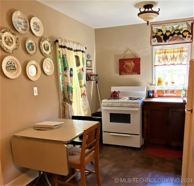 kitchen featuring sink and white gas stove