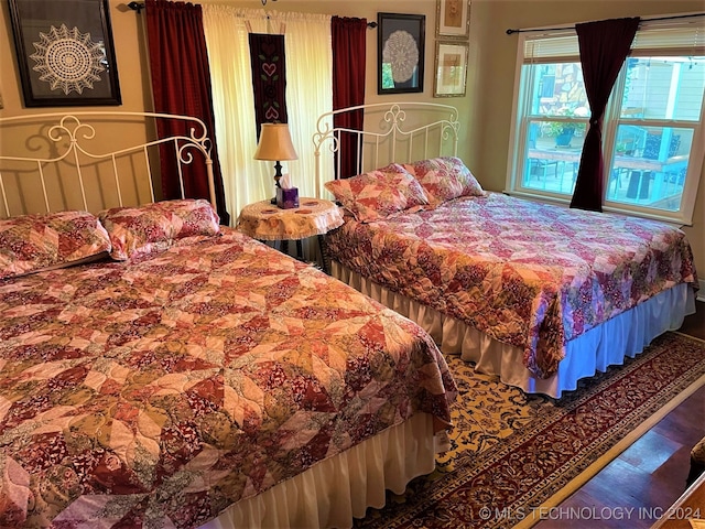 bedroom with wood-type flooring