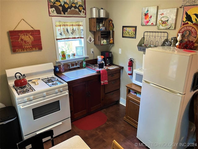 kitchen with white appliances, dark hardwood / wood-style floors, dark brown cabinetry, and sink