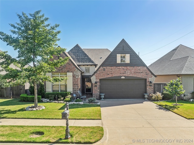 view of front of property featuring a garage and a front yard