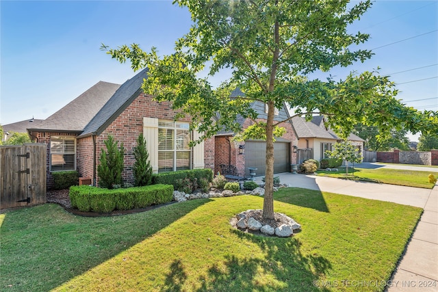 view of front of house with a garage and a front lawn