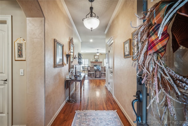 corridor with ornamental molding and dark hardwood / wood-style floors