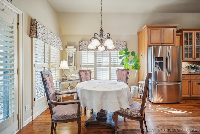 dining space with a notable chandelier and hardwood / wood-style flooring