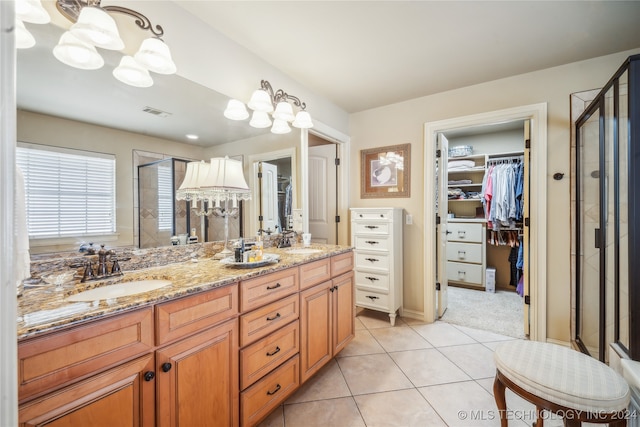 bathroom with tile patterned flooring, vanity, and an enclosed shower