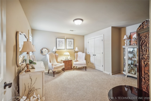 living area featuring light colored carpet