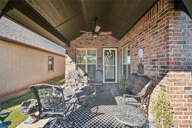 view of exterior entry featuring a patio and ceiling fan