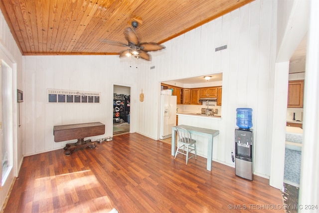 living room with ceiling fan, hardwood / wood-style flooring, wood ceiling, and wooden walls