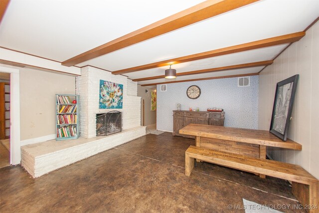 living room with a fireplace and beam ceiling