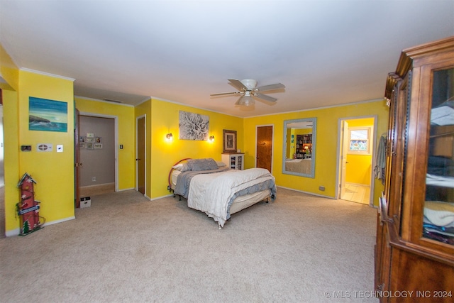 carpeted bedroom featuring ceiling fan and ornamental molding