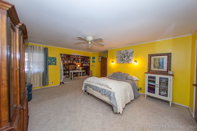 carpeted bedroom with ornamental molding and ceiling fan