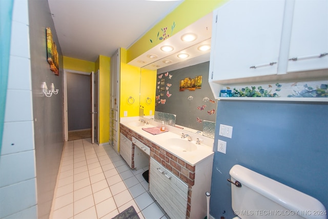 bathroom featuring tile patterned flooring, vanity, and toilet