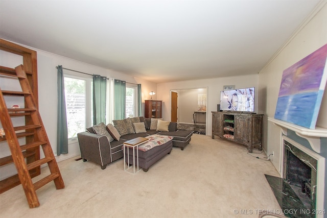 living room featuring a fireplace, ornamental molding, and light colored carpet