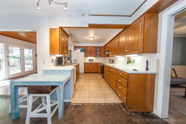 kitchen with white fridge with ice dispenser, electric range, light tile patterned floors, and crown molding