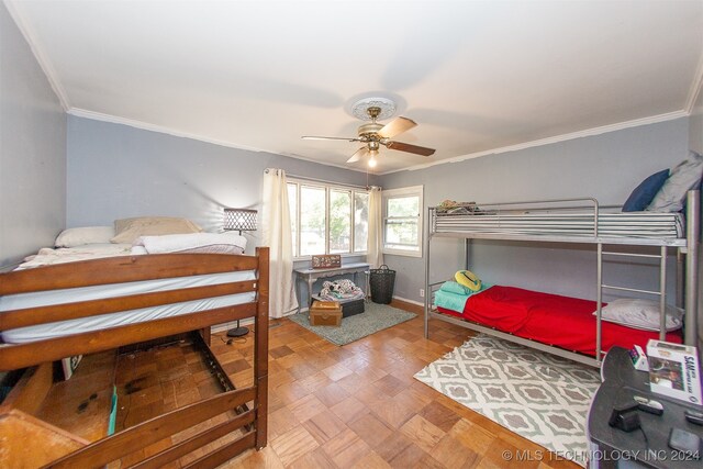 bedroom featuring ceiling fan, parquet floors, and ornamental molding