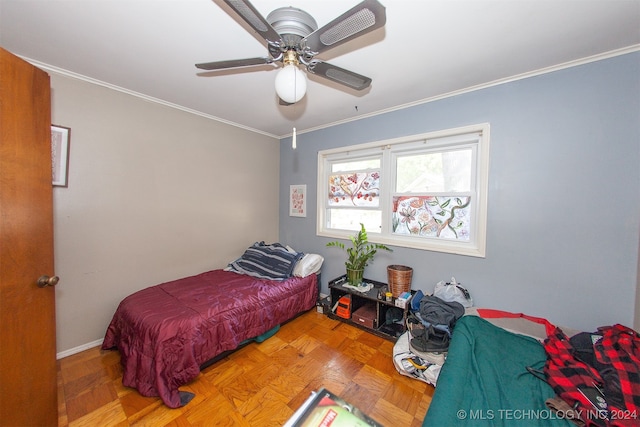 bedroom with ceiling fan, crown molding, and parquet floors