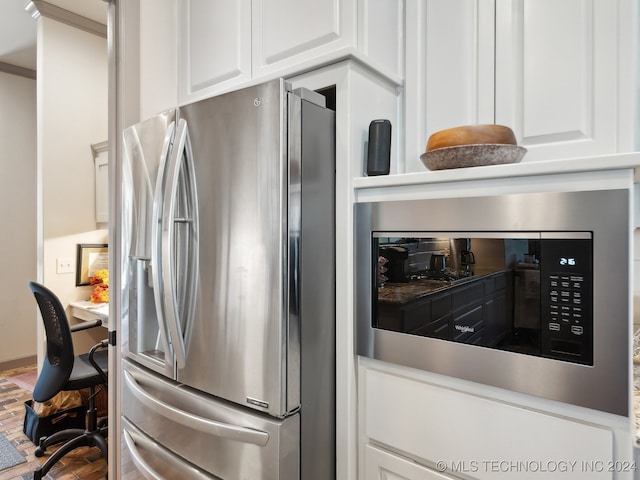 kitchen featuring wood-type flooring, white cabinetry, and appliances with stainless steel finishes