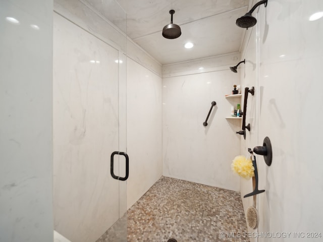 bathroom with a shower with door