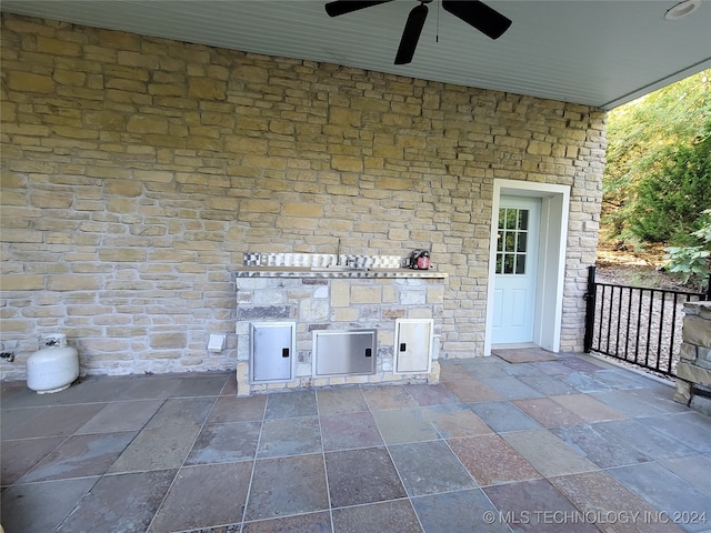 view of patio with ceiling fan and an outdoor kitchen