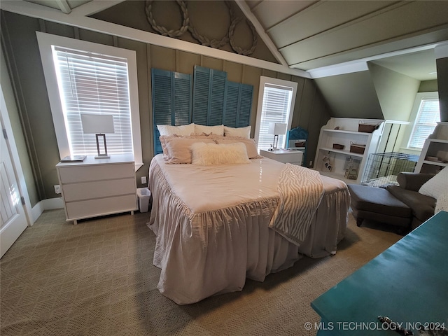 carpeted bedroom with vaulted ceiling with beams