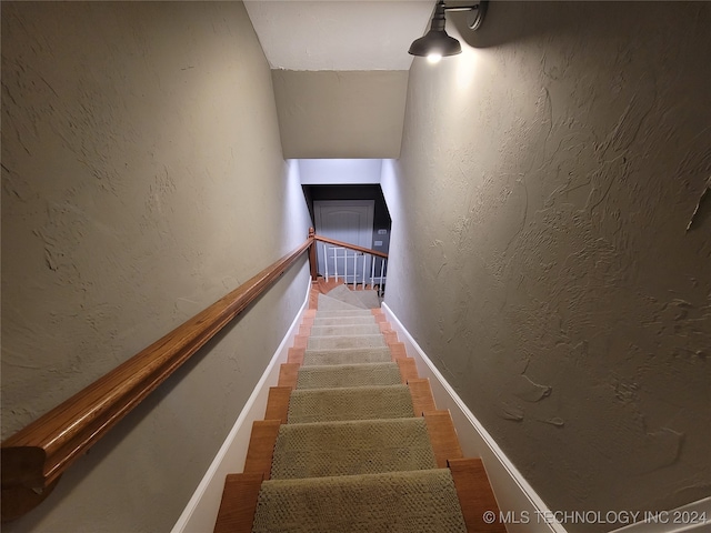 staircase featuring hardwood / wood-style flooring