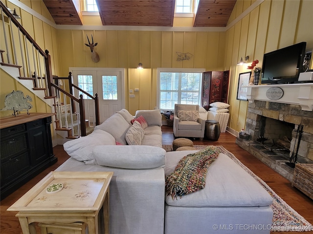 living room with high vaulted ceiling, dark hardwood / wood-style floors, and plenty of natural light