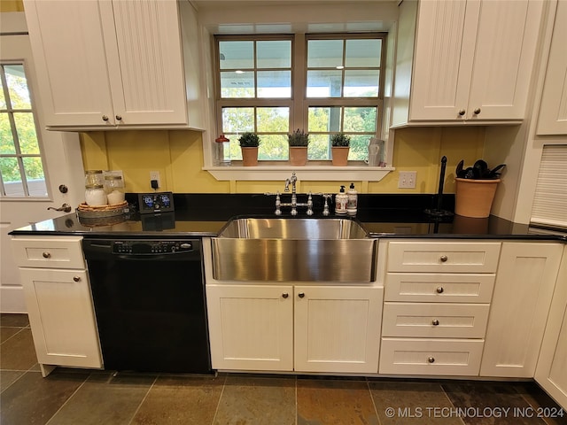 kitchen with black dishwasher, white cabinetry, and sink