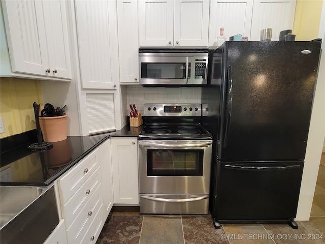 kitchen with white cabinets, backsplash, and appliances with stainless steel finishes