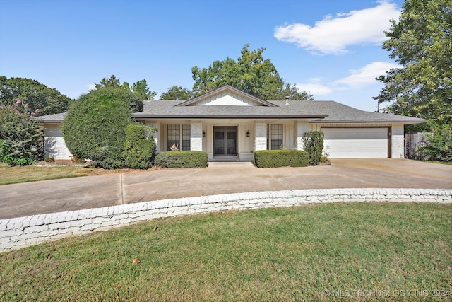 view of front of house with a garage and a front yard