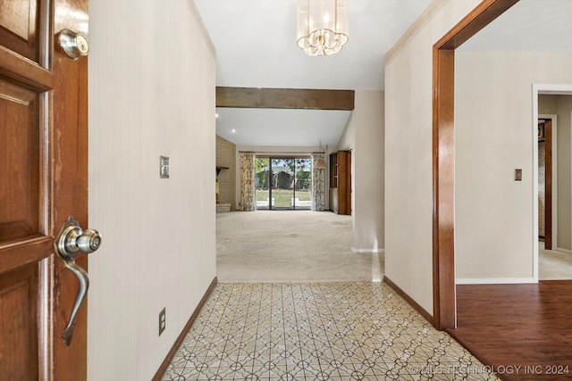 corridor featuring light colored carpet and a notable chandelier