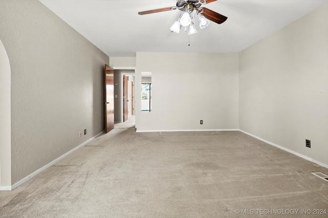 unfurnished room featuring light carpet and ceiling fan