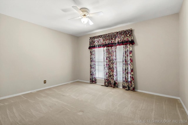 carpeted empty room featuring ceiling fan