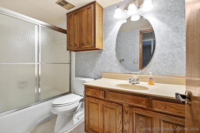 full bathroom with tile patterned flooring, vanity, enclosed tub / shower combo, and toilet