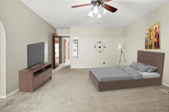 bedroom featuring light carpet and ceiling fan