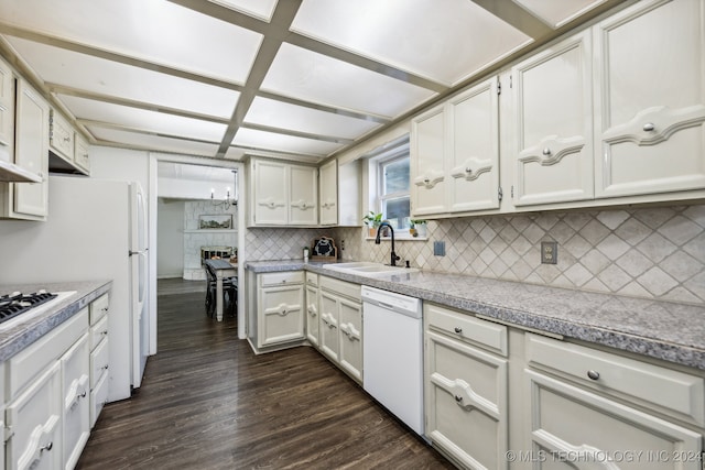 kitchen with white cabinets, backsplash, white dishwasher, dark hardwood / wood-style floors, and sink