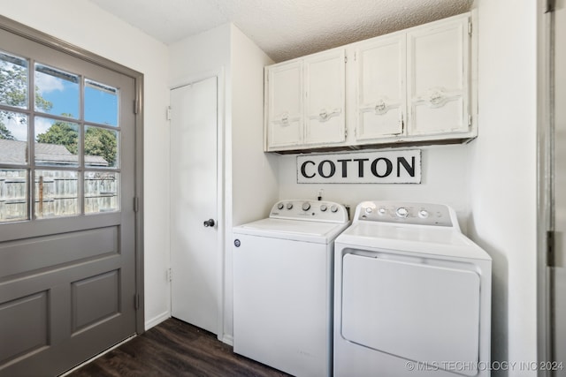 laundry area featuring cabinets, dark hardwood / wood-style flooring, a textured ceiling, and washing machine and dryer