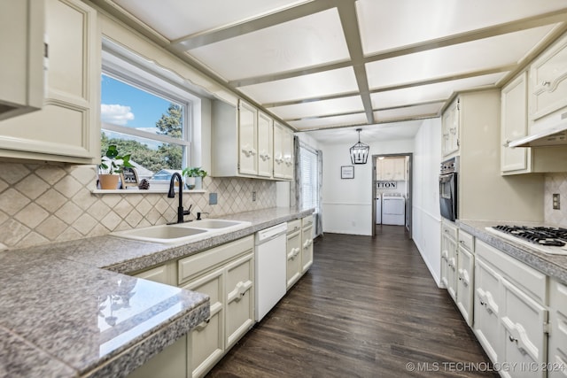 kitchen with pendant lighting, tasteful backsplash, dark wood-type flooring, sink, and white appliances