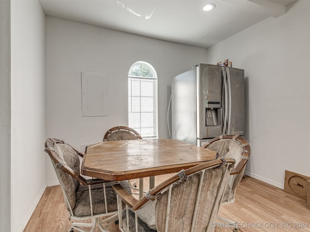 dining room with light wood-type flooring and electric panel