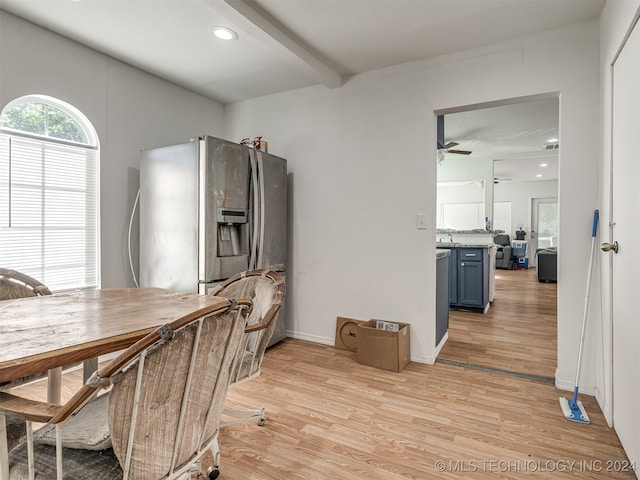 dining space featuring ceiling fan, beamed ceiling, and light wood-type flooring