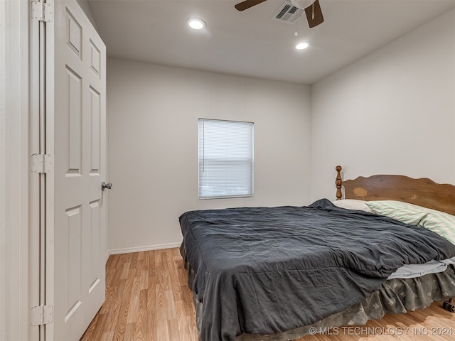 bedroom with light hardwood / wood-style floors and ceiling fan